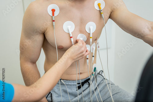 Medical professional conducting a cardiovascular evaluation with ecg electrodes photo
