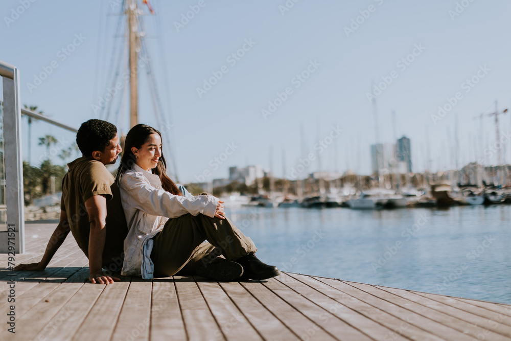 Serene afternoon at Barcelona marina, couple relaxing by tranquil waters