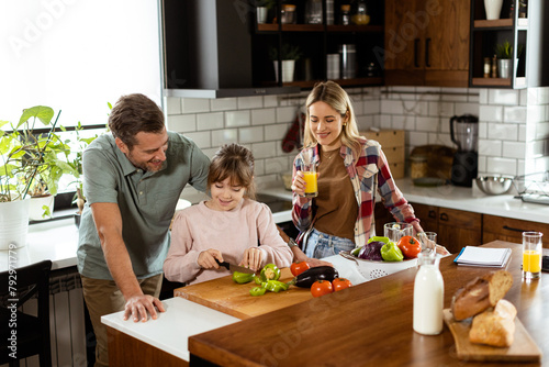 Family prepares a meal toge...