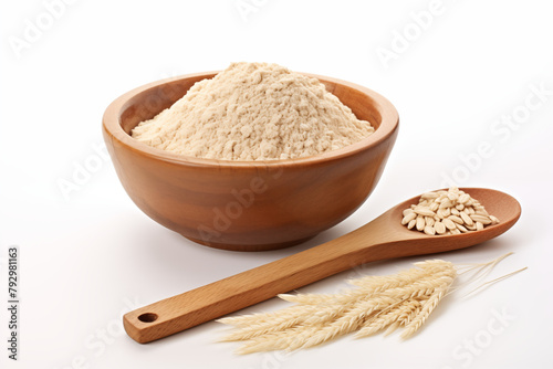 a wooden bowl of brown rice flour and 1 spoon of brown rice grains on a white background