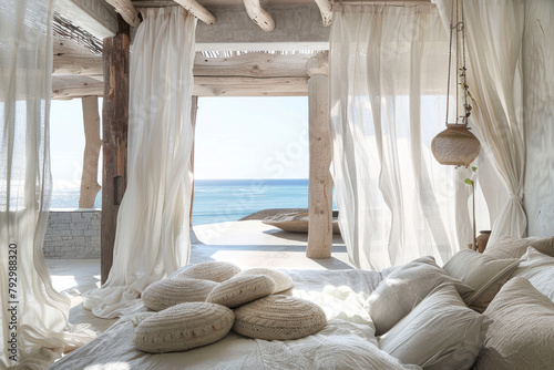 Coastal bohemian bedroom with whitewashed walls, driftwood accents, and billowing curtains.