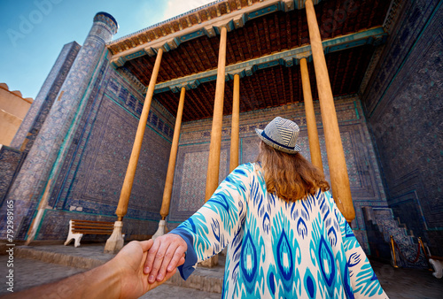 Woman tourist at old city Khiva in Uzbekistan photo