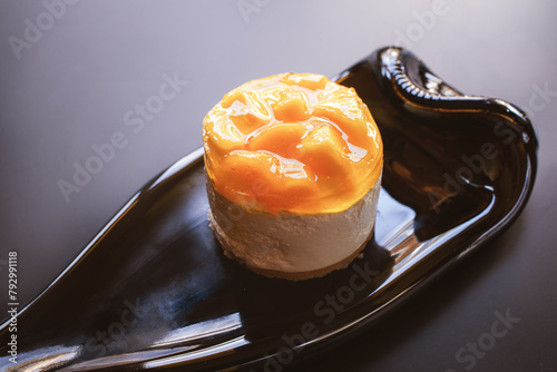 Mango tart soufflé cake on a lined plate made from a wine bottle