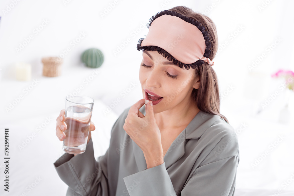 Photo of adorable pretty lady wear grey nightwear drinking water vitamins indoors apartment bedroom Photo of adorable pretty lady wear grey nightwear drinking water vitamins indoors apartment bedroom
