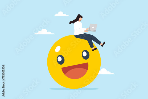 Businesswoman works on her laptop while sitting on smiling face emoji. Concept of finding joy and satisfaction in work, passion, enjoyment, positive relationship with company, and employee wellbeing © VZ_Art