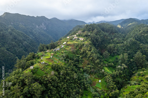 Madeira Island landscape  small village on hills and green lush forest. Aerial drone view. Portugal travel.