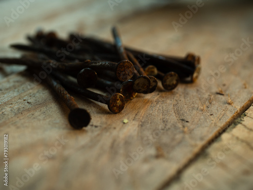 Rusty old nails on wooden background 