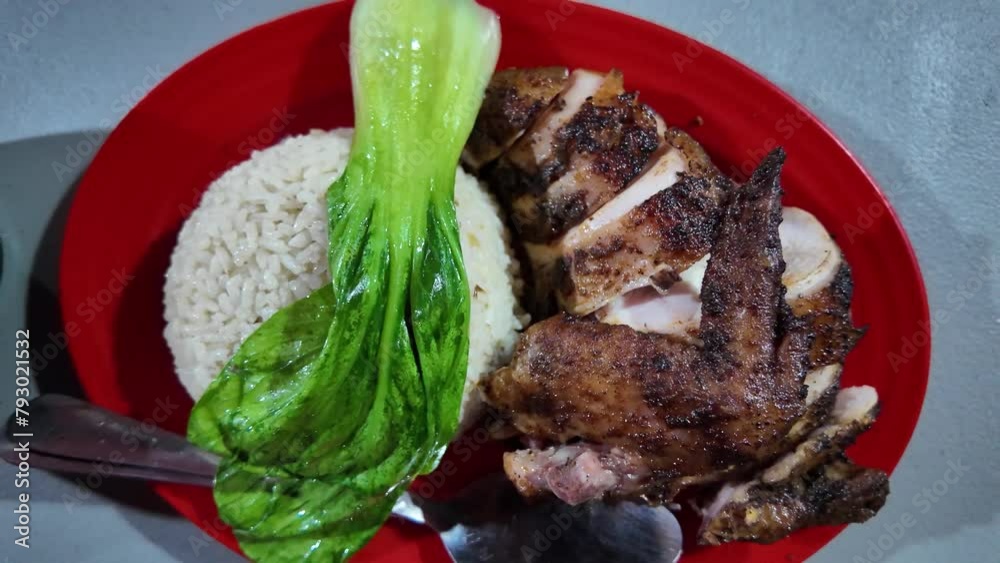 Hainanese Rice with roasted chicken slices and green bok choy garnish on red plate. Concept for asian street food. 4k video footage