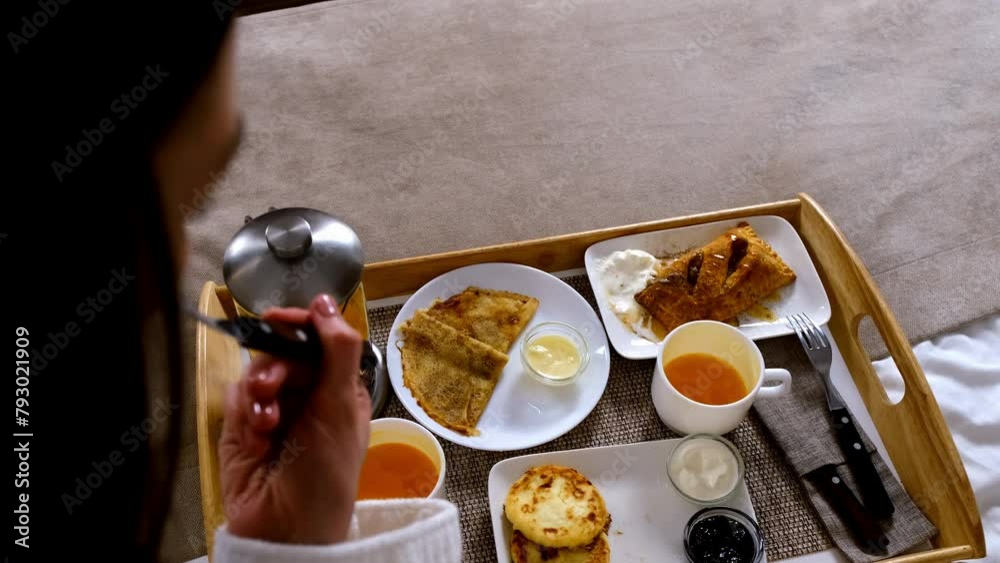 custom made wallpaper toronto digitalWoman is eating desserts in bed from wooden tray in hotel room on vacations, top view. Pancakes, cheesecakes, pastry with tea and ice-cream, condensed milk, sour cream and jam. Resting and relax.