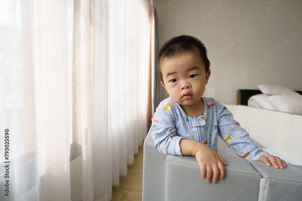 Sleepy Asian baby boy waking up at window Sleepy Asian baby boy waking up at window