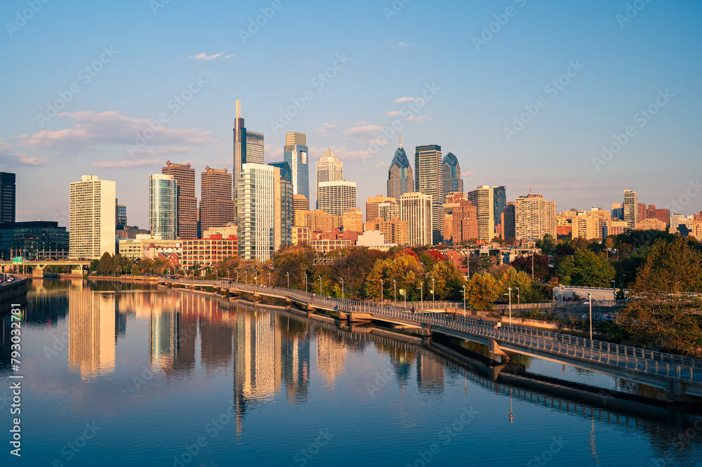 Naklejka premium city skyline at sunset looks from over the river