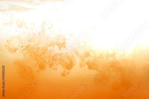 Orange color dye melt on white background,Abstract smoke pattern,Colored liquid dye,Splash paint