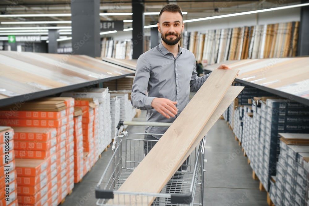 man choosing laminate samples in hardware store man choosing laminate samples in hardware store