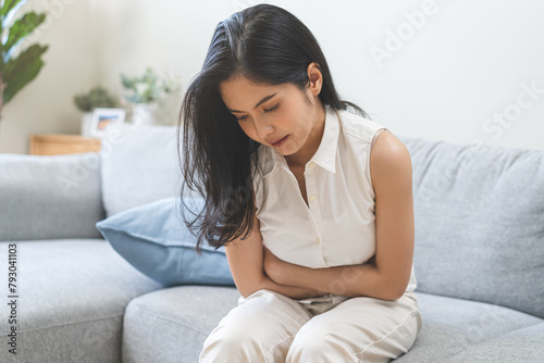 Flatulence ulcer, asian young woman, girl hands in belly, stomach pain from food poisoning, abdominal pain and digestive problem, gastritis or diarrhea. Abdomen inflammation, menstrual period people. photo
