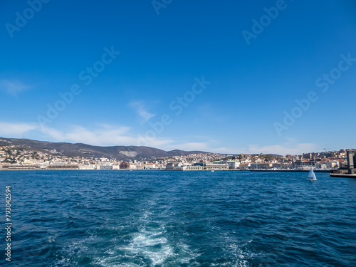 Scenic view from a ferry of the port of Trieste from in Friuli-Venezia Giulia, Italy, Europe. Blue sky in tranquil atmosphere at Adriatic Mediterranean sea in summer. Boat tour along the coastline © Chris