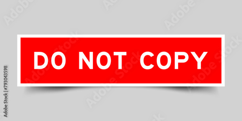 Red color square label sticker with word do not copy that inserted in gray background