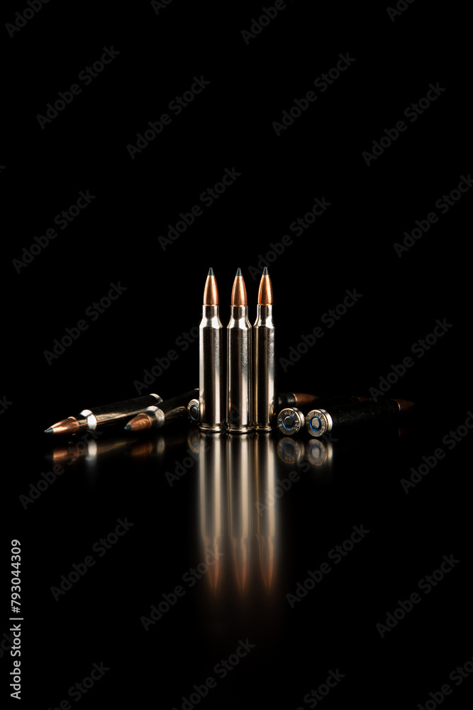 Obraz premium Bullet isolated on black background with reflexion. Rifle bullets close-up on black back. Cartridges for rifle and carbine on a black.