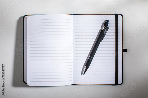 Open lined notebook with pen photo
