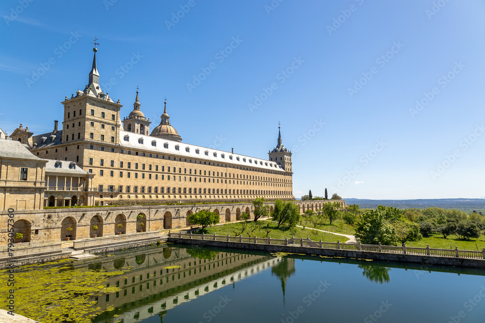 Real Monasterio de San Lorenzo de El Escorial historic building with gardens landscaped plants with artificial lake Madrid, Spain