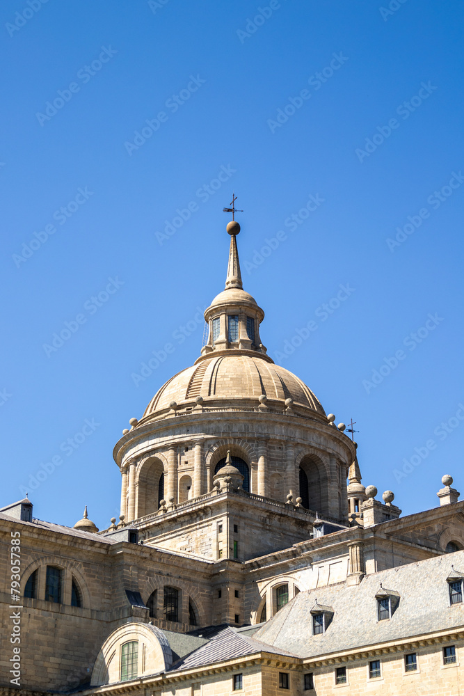 The sculptural details and the emblematic dome of the Monastery of El Escorial with its roofs