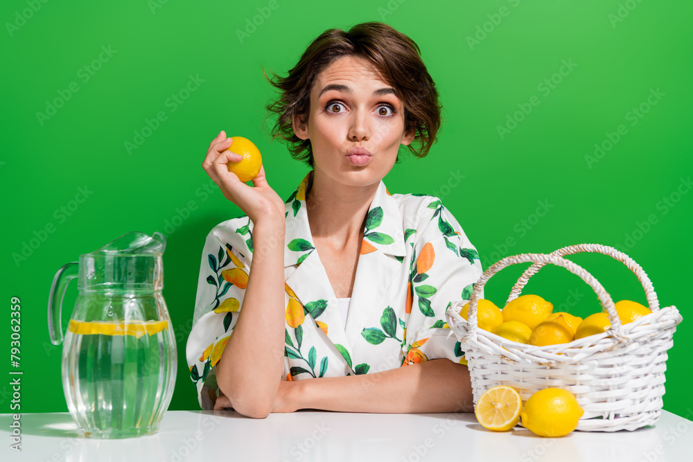 Photo of spring sour lemons grown young girl collect fresh fruits every year harvest make juice isolated on green color background - obrazy, fototapety, plakaty 