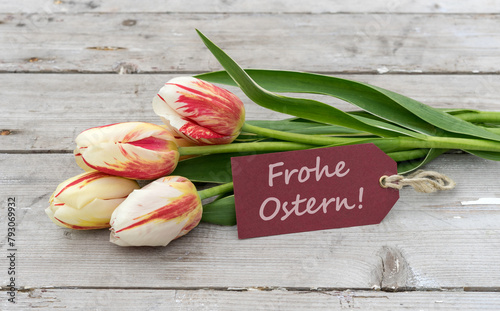 Greeting card with red, yellow and white tulips and german text: Happy Easter