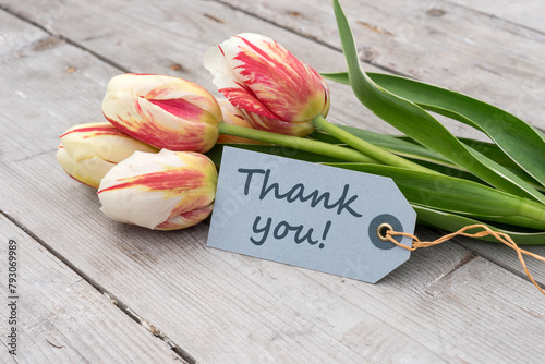 Greeting card with red, yellow and white tulips and english text: Thank you