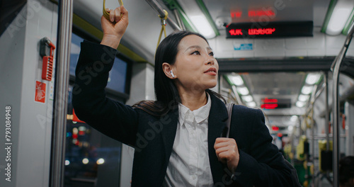 Canvas Print Satisfied woman using earphones while listening favourite music