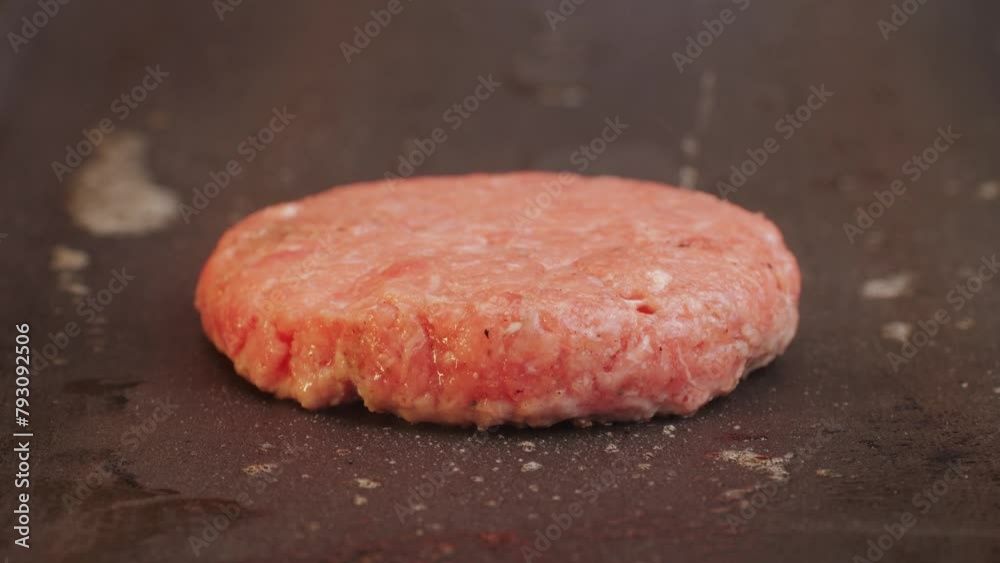 Cooking American fat smash burger on grill close-up. Beef or pork cutlet smashing by burger press. The chef in kitchen of the restaurant making cutlets for burgers - smash Cooking American fat smash burger on grill close-up. Beef or pork cutlet smashing by burger press. The chef in kitchen of the restaurant making cutlets for burgers - smash