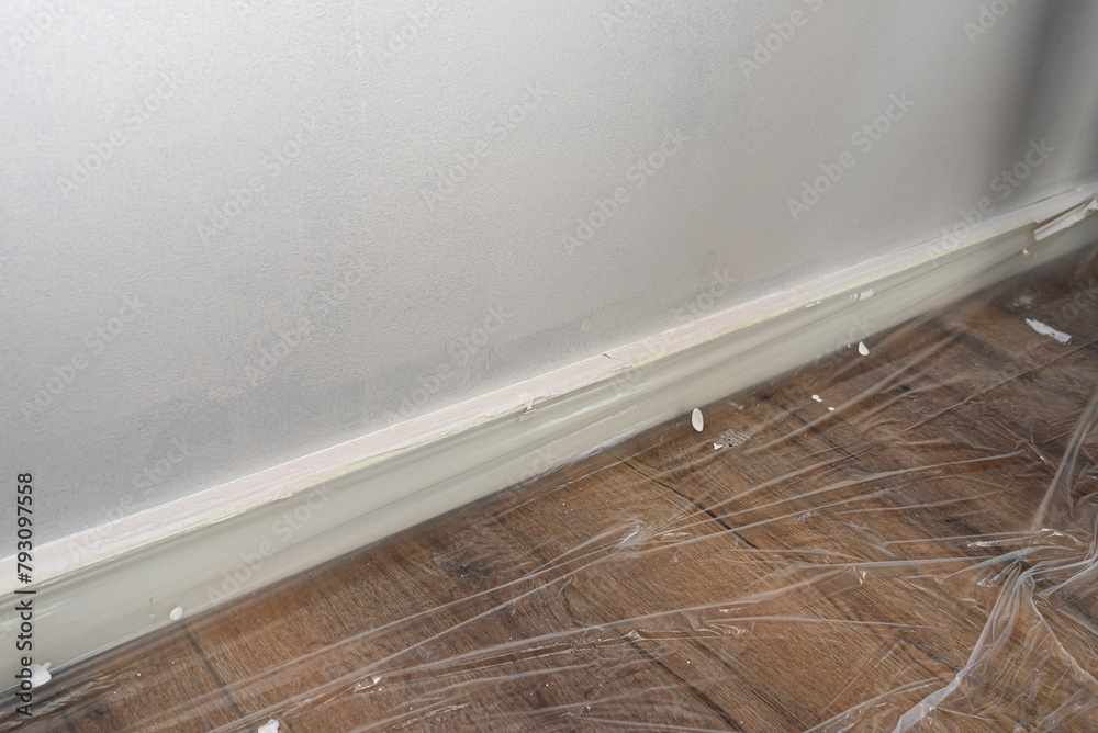 The vinyl floor is protected with foil before painting and covered with painters tape. The vinyl floor is protected with foil before painting and covered with painters tape.