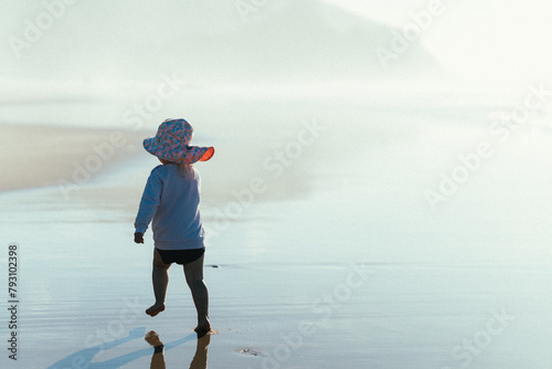Little girl running at the beach 