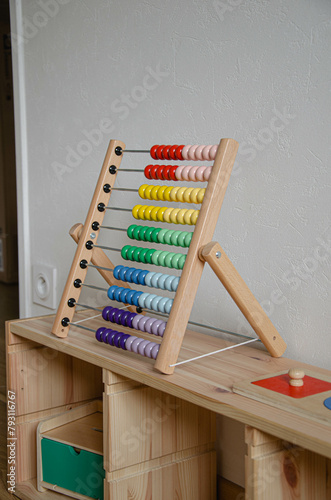 Un boulier en bois Montessori sur un meuble en bois