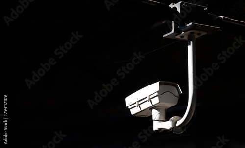 Surveillance or security CCTV camera on a rod on a black background. Copy space
