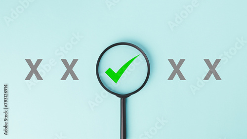 A magnifying glass is placed over green check mark and cross icon in the side. Concept of quality control, approval and satisfaction.