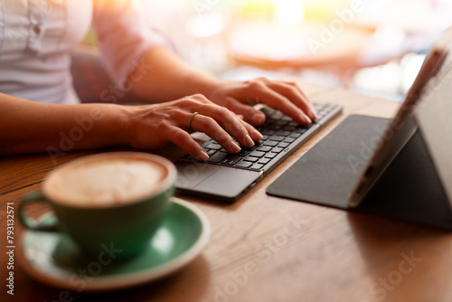 Woman using wifi keyboord to write on tablet