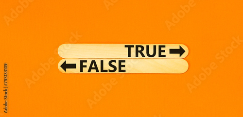 True or false symbol. Concept word True or False on beautiful wooden stick. Beautiful orange table orange background. Business and true or false concept. Copy space. photo