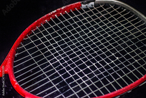Red tennis racket with white powder