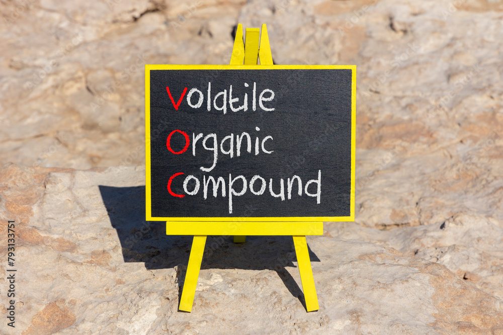 Fototapeta premium VOC volatile organic compound symbol. Concept words VOC volatile organic compound on beautiful yellow blackboard. Beautiful stone background. Business VOC volatile organic compound concept. Copy space