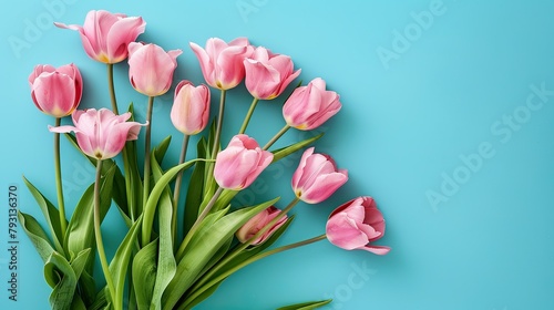 A stunning spring bouquet of pink tulip flowers set against a vibrant blue background with ample space for text or design