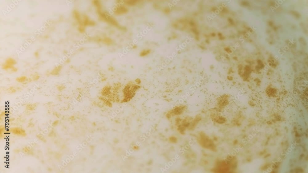 Glitter particles. Stained fluid. Defocused yellow golden rotating shiny blotch sparks on ink surface messy art cloud abstract on white background. Glitter particles. Stained fluid. Defocused yellow golden rotating shiny blotch sparks on ink surface messy art cloud abstract on white background.