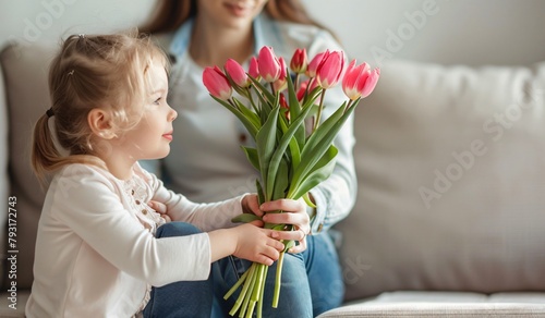 Little girl gives her mother flowers 