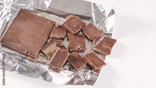 Milk chocolate made from high-quality cocoa. Cocoa and chocolos on white background, concept of price increase for raw materials of chocolate production.