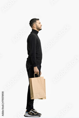 A man, full-length, on a white background, with bags