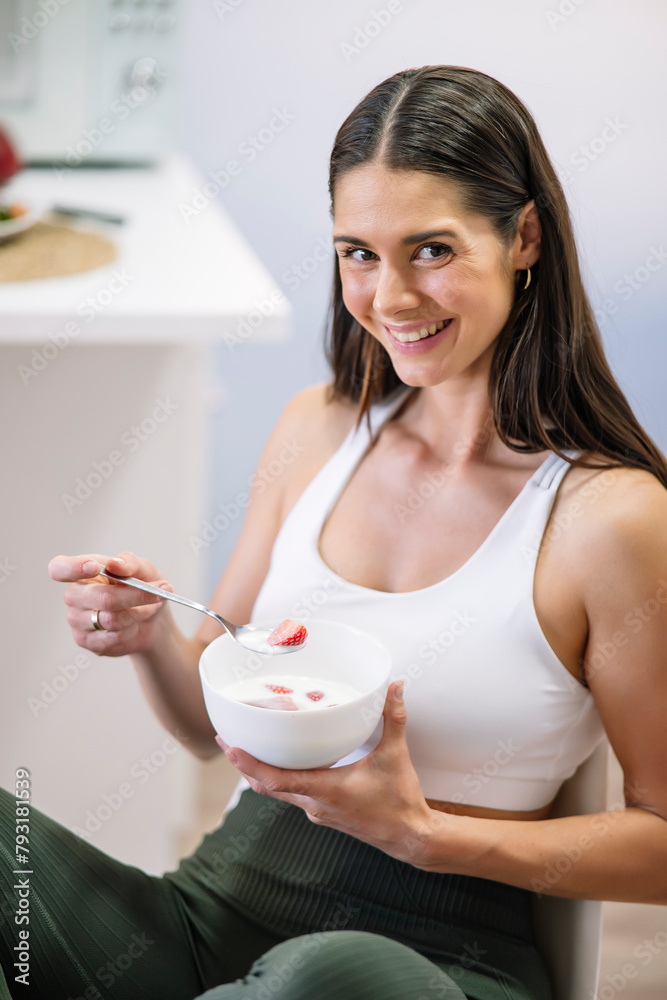 Athletic woman enjoying healthy meal at home