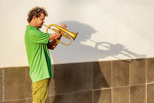 Inspiring One-Armed Trumpeter Performing on Street photo