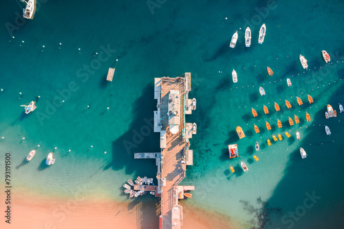 Colorful Warm Pier with Docked Boats and Shadows