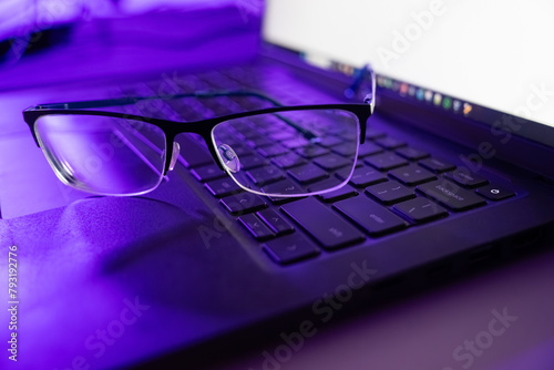Tech Harmony: Eyeglasses on Laptop Keyboard