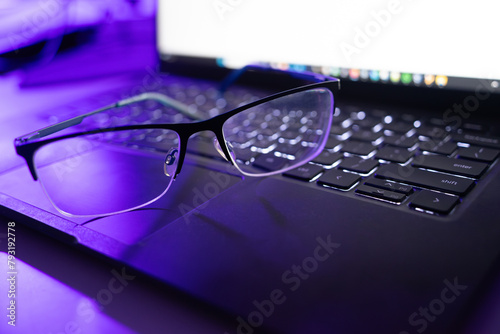 Modern Technology: Glasses Resting on Laptop Keyboard