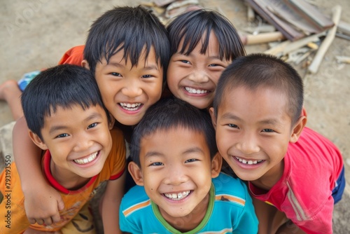 Group of happy asian children smiling and looking at the camera. © Inigo