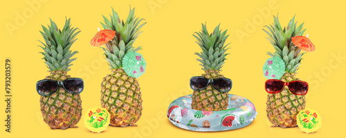 Tropical summer vacation concept with funny stylish pineapples isolated on yellow background. © Nancy Pauwels